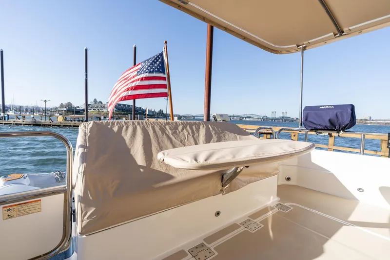 Slide: The Image of 2013 Sabre 38 Salon Express boat deck with American flag, docked by the water. - 88