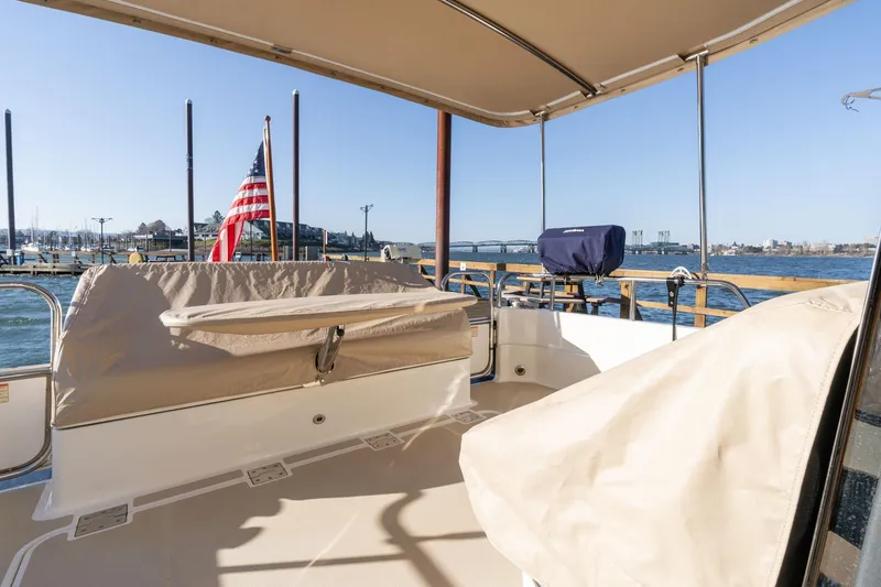 Slide: The Image of 2013 Sabre 38 Salon Express boat deck with American flag, marina view. - 89