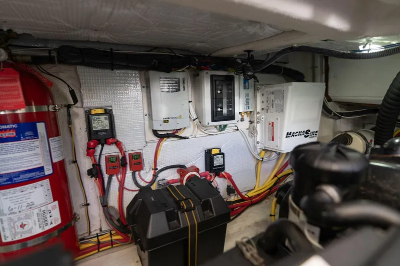 Slide: The Image of Engine room of 2013 Sabre 38 Salon Express with electrical systems and fire extinguisher. - 91