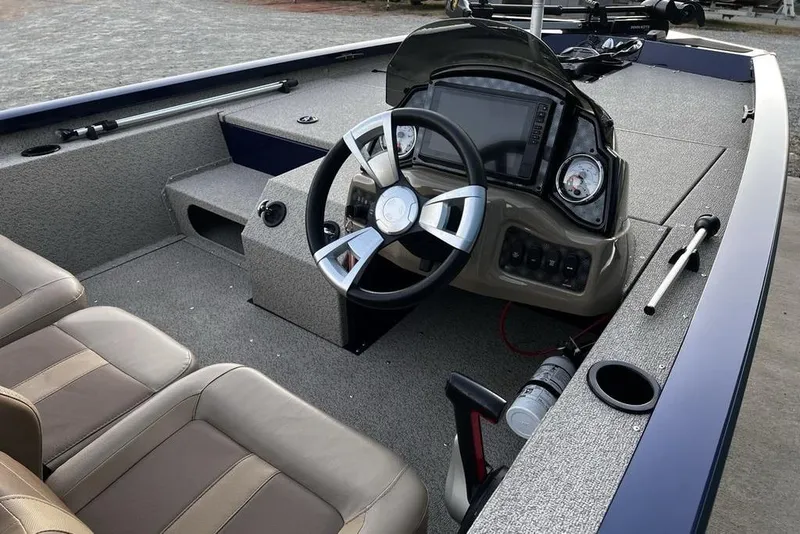 Slide: The Image of 2023 G3 Sportsman 1710 boat interior with steering wheel and dashboard controls. - 14