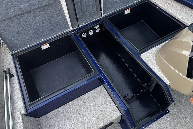 Slide: The Image of 2023 G3 Sportsman 1710 boat storage compartments, open and empty, showcasing interior space. - 16