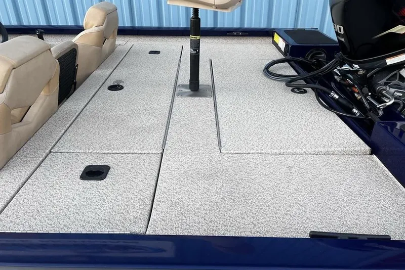 Slide: The Image of 2023 G3 Sportsman 1710 boat interior with seating and motor, featuring a spacious deck. - 9