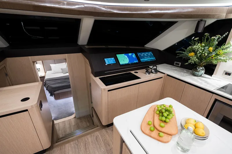 Slide: The Image of Manufacturer Provided Image: Luxurious interior of 2026 Aquila 70 yacht with modern kitchen and cozy bedroom. - 12