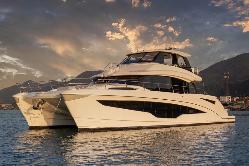 Slide: The Image of Manufacturer Provided Image: 2026 Aquila 70 Luxury yacht on serene water at sunset. - 2