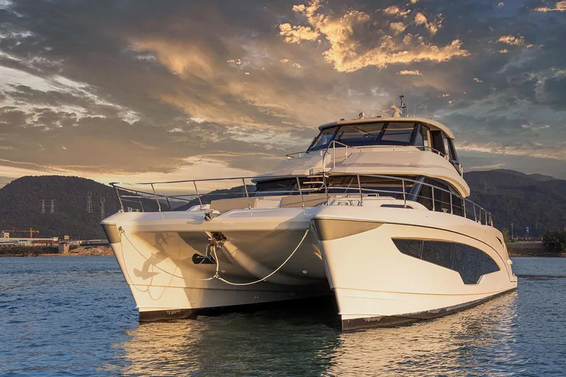 Slide: The Image of Manufacturer Provided Image: 2026 Aquila 70 Luxury yacht on serene water at sunset. - 4