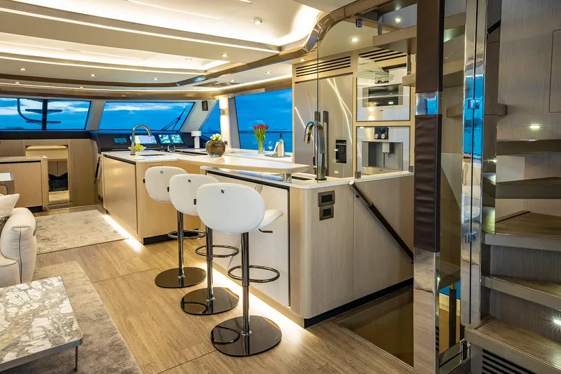 Slide: The Image of Manufacturer Provided Image: Luxurious interior of 2026 Aquila 70 yacht featuring modern kitchen and seating area. - 8