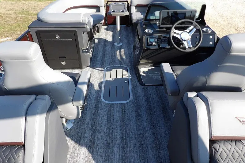 Slide: The Image of Interior of 2026 Bennington M Quad Bench 22 MFB pontoon boat with modern seating and controls. - 14