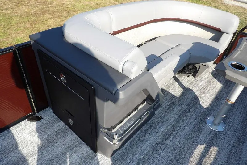 Slide: The Image of 2026 Bennington M Quad Bench 22 MFB boat interior with gray seating and storage. - 17