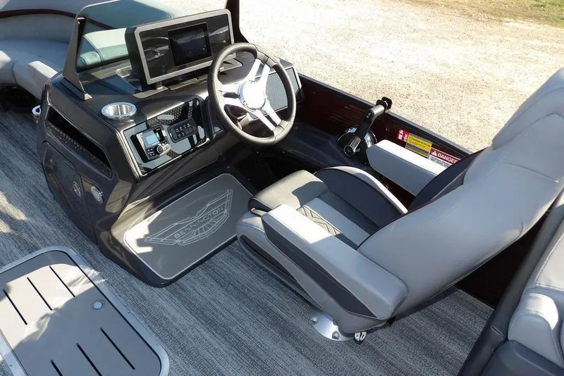 Slide: The Image of 2026 Bennington M Quad Bench 22 MFB boat interior with modern steering and controls. - 25