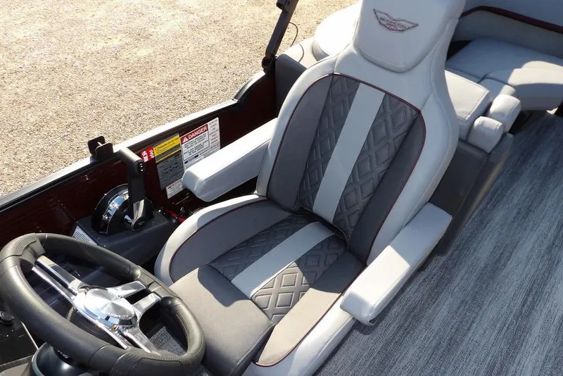 Slide: The Image of 2026 Bennington M Quad Bench 22 MFB boat interior with luxury seating and steering wheel. - 32