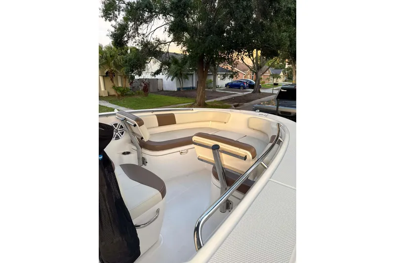 Slide: The Image of 2017 Robalo R200ES boat interior with cushioned seating and stainless steel railings. - 7