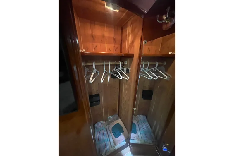 Slide: The Image of Wooden closet interior with hangers in a 2004 Carver 570 Voyager Pilothouse yacht. - 40