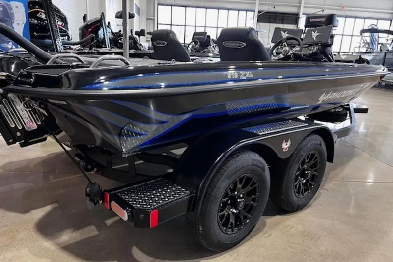 Slide: The Image of 2026 Phoenix 919 ZXL boat on trailer, sleek black design with blue accents. - 1
