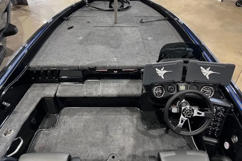 Slide: The Image of 2026 Phoenix 919 ZXL boat interior with dual screens and steering wheel, featuring gray carpeting. - 15