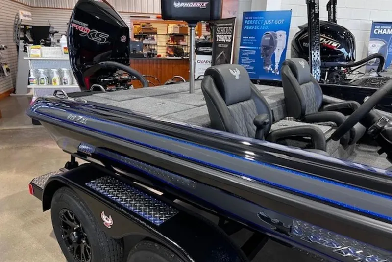 Slide: The Image of 2026 Phoenix 919 ZXL boat in showroom, featuring sleek design and comfortable seating. - 4