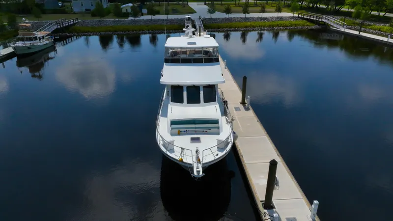 Slide: The Image of 2005 Jefferson Marquessa 60 MY yacht docked in a serene marina setting. - 12