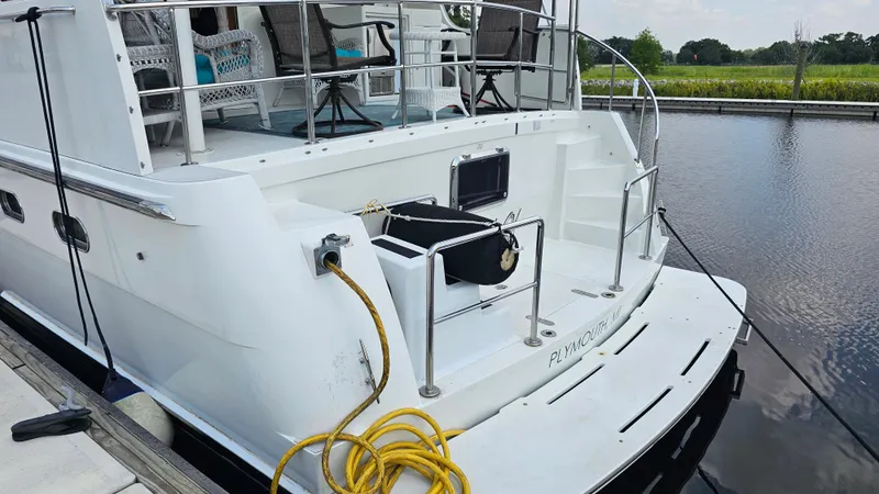 Slide: The Image of 2005 Jefferson Marquessa 60 MY yacht docked, featuring spacious deck and seating area. - 14