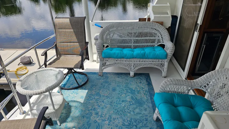 Slide: The Image of Deck of 2005 Jefferson Marquessa 60 MY with wicker furniture and blue cushions. - 20