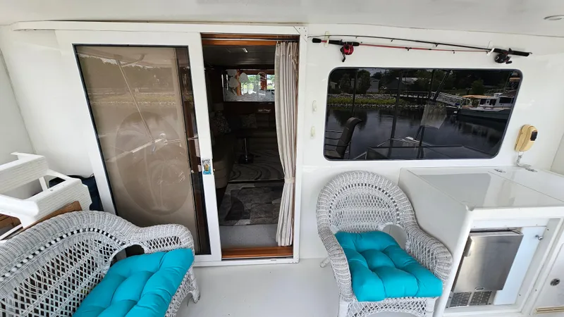 Slide: The Image of 2005 Jefferson Marquessa 60 MY yacht deck with wicker seating and marina view. - 25