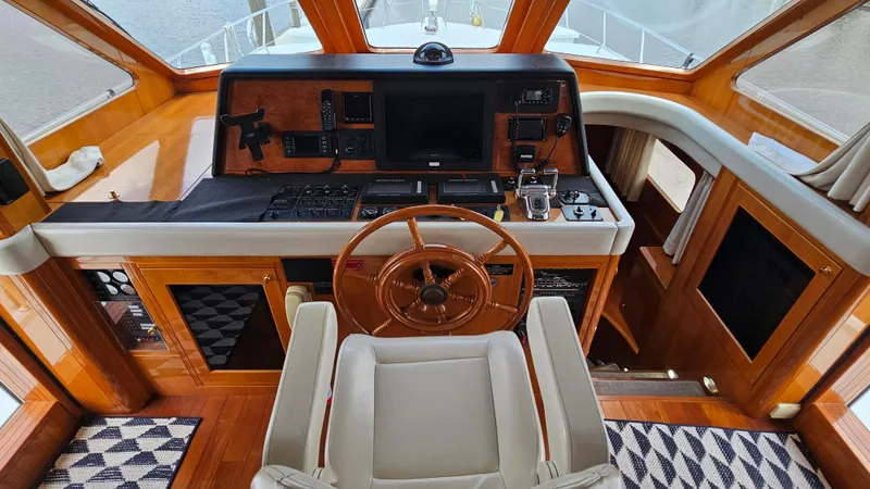 Slide: The Image of Helm of 2005 Jefferson Marquessa 60 MY yacht with wooden steering wheel and navigation controls. - 37