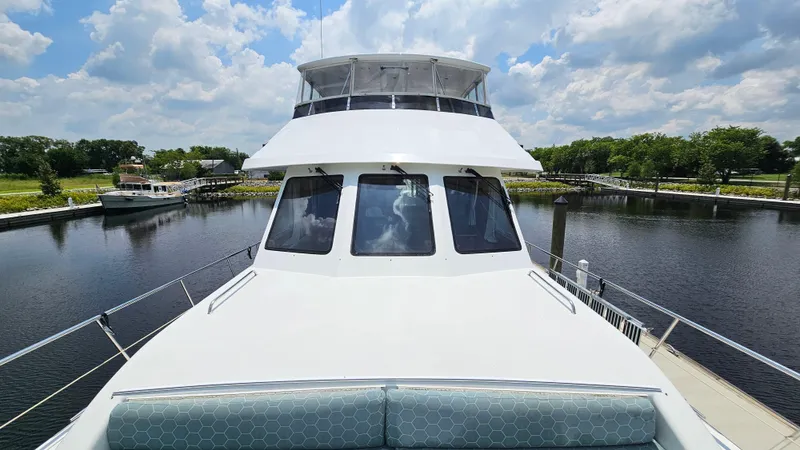 Slide: The Image of Jefferson Marquessa 60 MY yacht docked, showcasing sleek design under a partly cloudy sky. - 49
