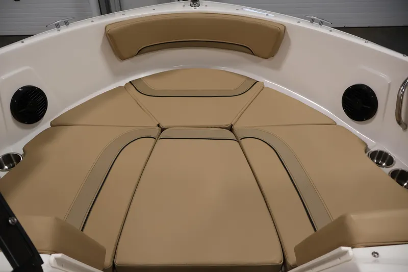 Slide: The Image of 2026 Bayliner V20 boat interior with tan cushioned seating and cup holders. - 10