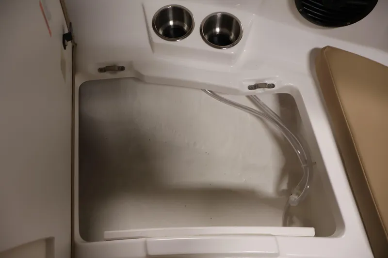 Slide: The Image of Interior of 2026 Bayliner V20 boat with cup holders and storage compartment. - 11