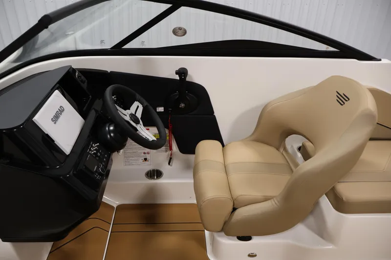 Slide: The Image of Interior of 2026 Bayliner V20 boat with steering wheel and beige seating. - 13