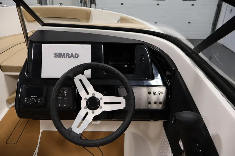 Slide: The Image of 2026 Bayliner V20 boat dashboard with Simrad navigation system and steering wheel. - 14