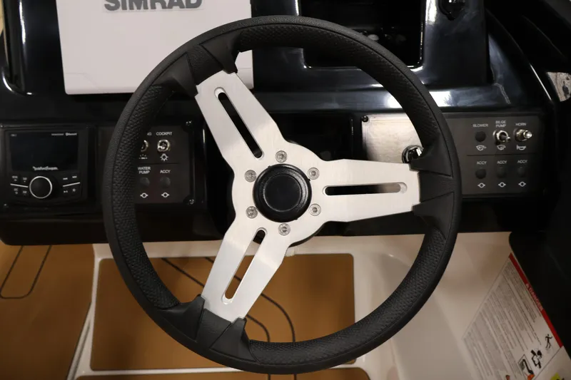 Slide: The Image of Steering wheel and dashboard controls of 2026 Bayliner V20 boat. - 15