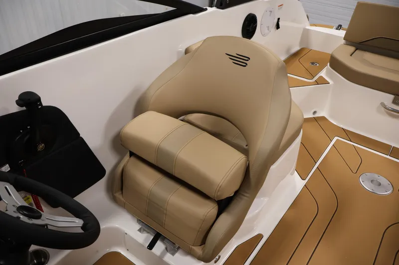 Slide: The Image of 2026 Bayliner V20 boat interior with tan seating and modern steering wheel. - 21