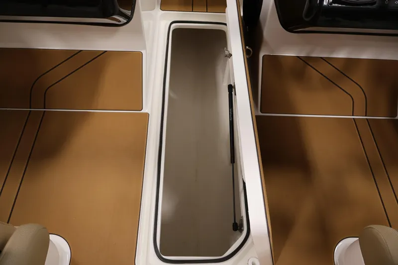 Slide: The Image of 2026 Bayliner V20 interior with open storage compartment and sleek brown flooring. - 27