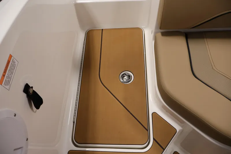 Slide: The Image of 2026 Bayliner V20 boat interior with tan seating and wood-style flooring. - 30
