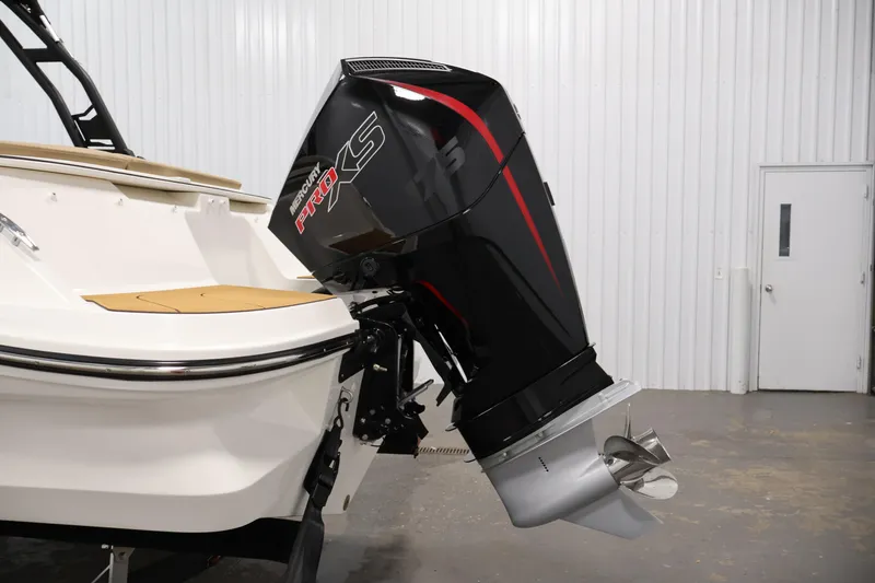 Slide: The Image of 2026 Bayliner V20 boat with Mercury Pro XS outboard motor in a showroom. - 33