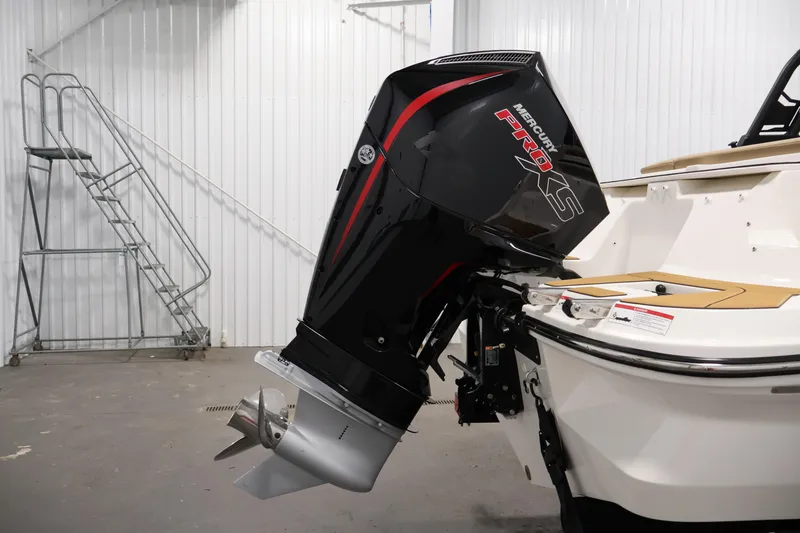 Slide: The Image of 2026 Bayliner V20 boat with Mercury Pro XS outboard motor in a garage setting. - 34