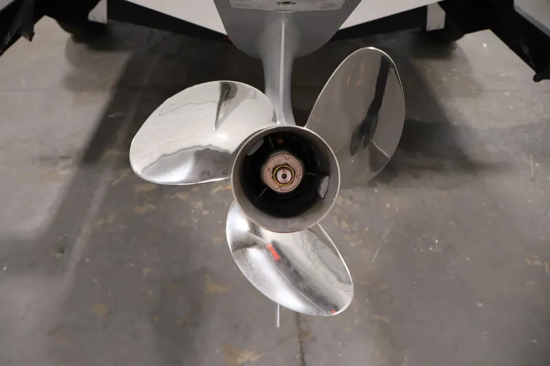 Slide: The Image of Close-up of a 2026 Bayliner V20 boat propeller on a concrete floor. - 35