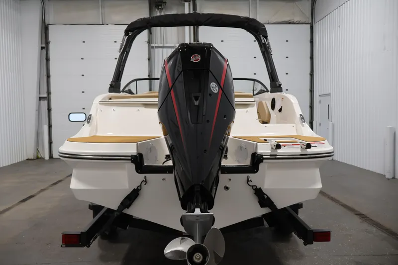 Slide: The Image of 2026 Bayliner V20 boat with outboard motor in a garage setting. - 5