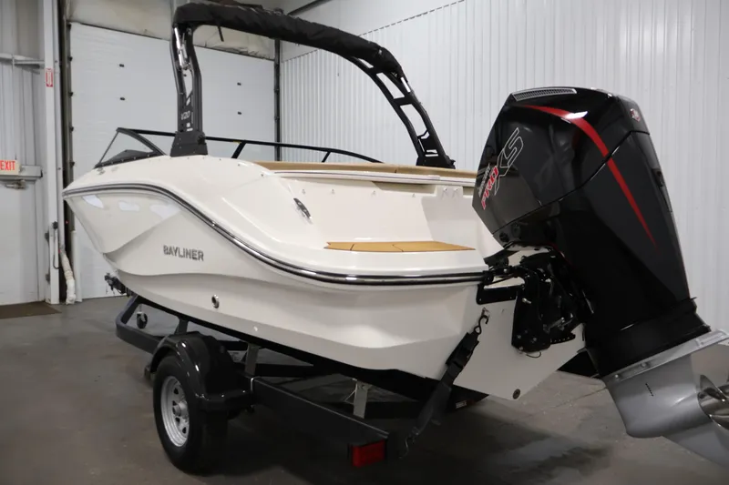 Slide: The Image of 2026 Bayliner V20 boat with outboard motor in a garage setting. - 6