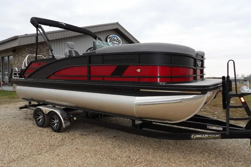 The Image of 2026 Bennington M Swingback 22 MSB pontoon boat on trailer, parked outdoors. - 1