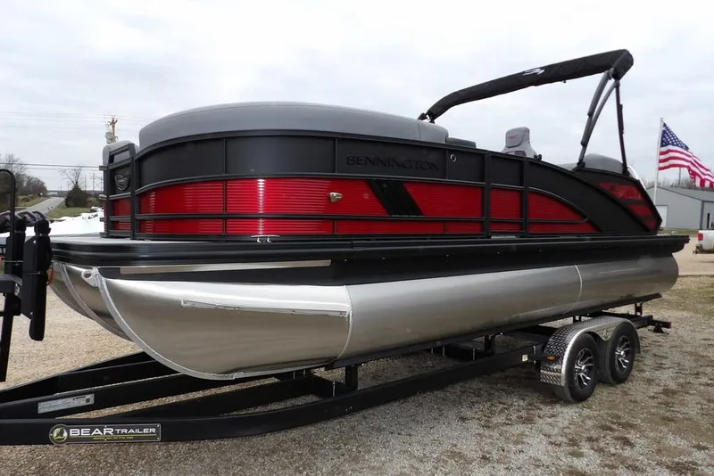 Slide: The Image of 2026 Bennington M Swingback 22 MSB pontoon boat on trailer, featuring sleek design and vibrant colors. - 10