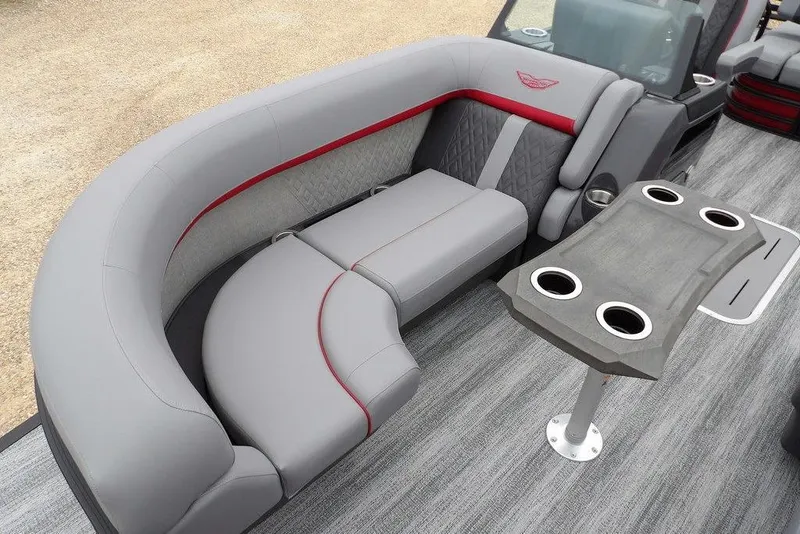 Slide: The Image of 2026 Bennington M Swingback 22 MSB boat interior with gray seating and cupholder table. - 15