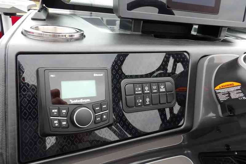 Slide: The Image of 2026 Bennington M Swingback 22 MSB dashboard with control panel and audio system. - 22