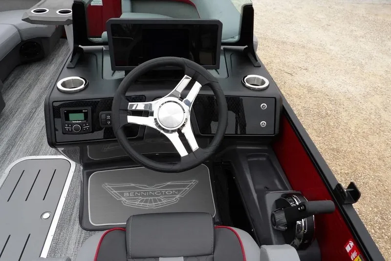 Slide: The Image of 2026 Bennington M Swingback 22 MSB boat dashboard with steering wheel and controls. - 25