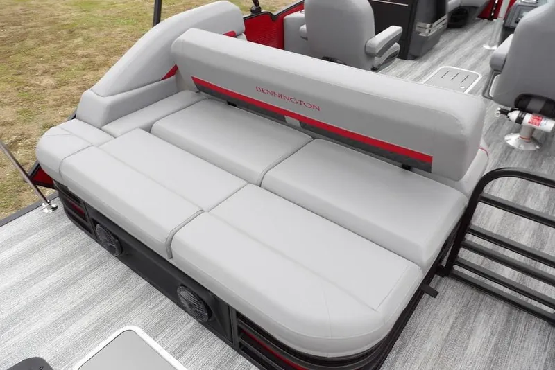 Slide: The Image of 2026 Bennington M Swingback 22 MSB boat interior with gray seating and red accents. - 29