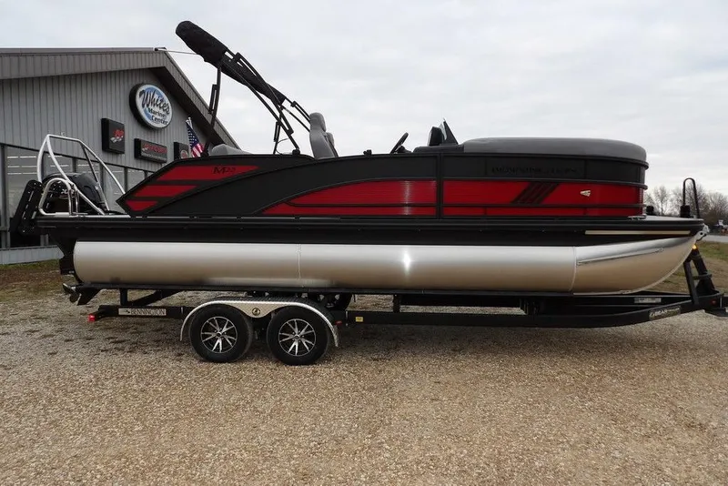 Slide: The Image of 2026 Bennington M Swingback 22 MSB pontoon boat on trailer, parked outside dealership. - 3