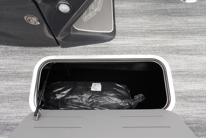 Slide: The Image of Storage compartment of 2026 Bennington M Swingback 22 MSB boat, open with contents inside. - 30
