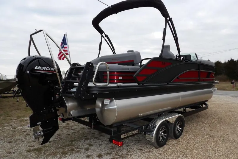 Slide: The Image of 2026 Bennington M Swingback 22 MSB pontoon boat on trailer, featuring Mercury engine. - 4