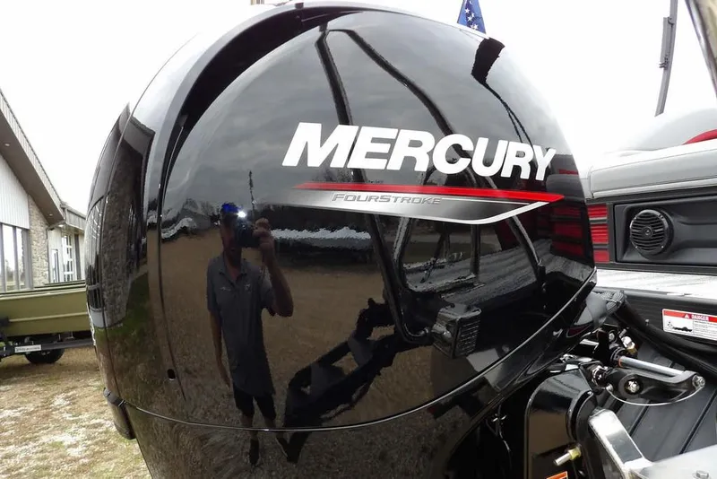 Slide: The Image of Mercury FourStroke engine on 2026 Bennington M Swingback 22 MSB boat, reflecting surroundings. - 41