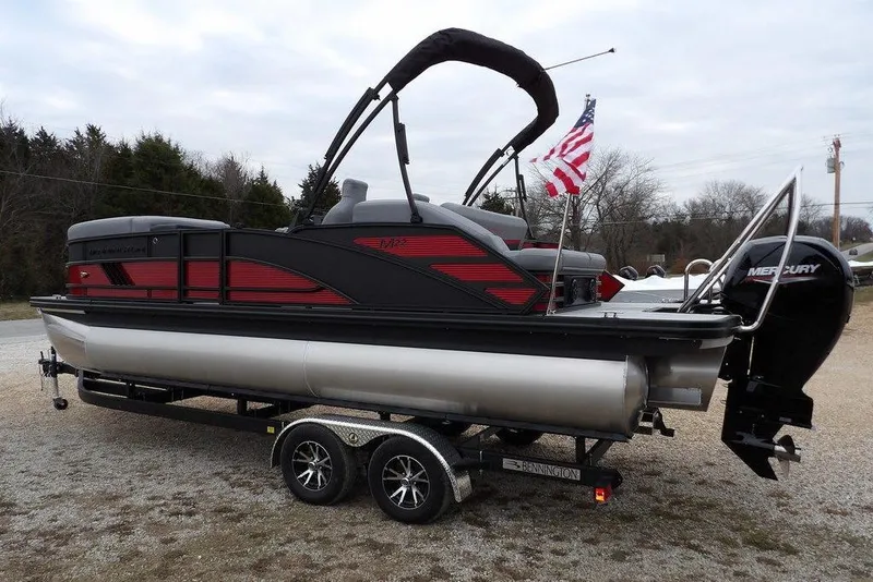 Slide: The Image of 2026 Bennington M Swingback 22 MSB pontoon boat on trailer, featuring Mercury engine. - 6
