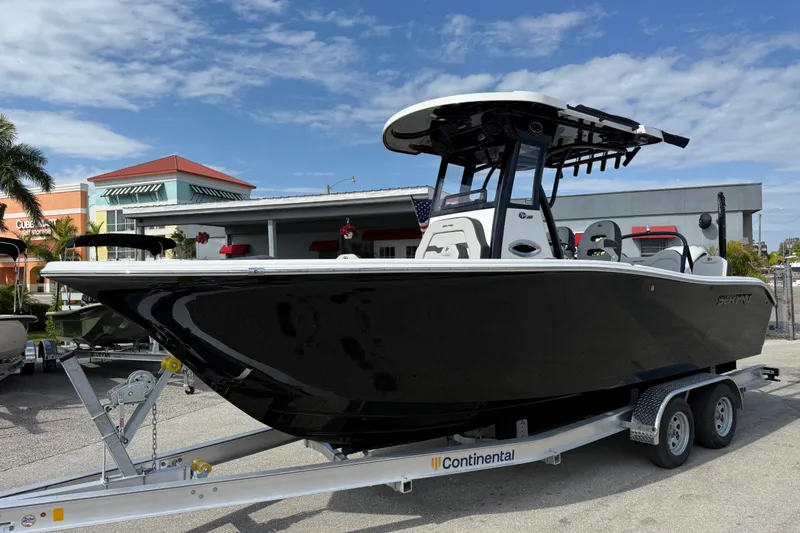 The Image of 2025 Sea Pro 245FLX Sandbar boat on trailer, displayed outdoors under blue sky. - 1